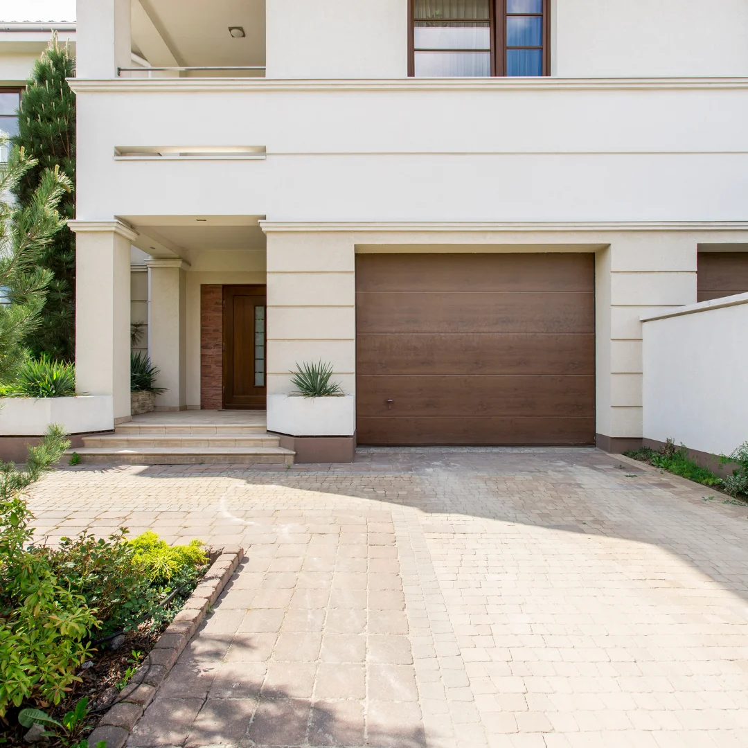 A white house with a brown garage door