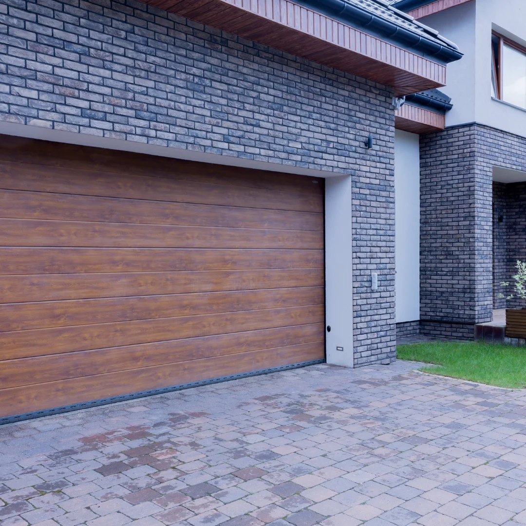 A brick house with a wooden garage door