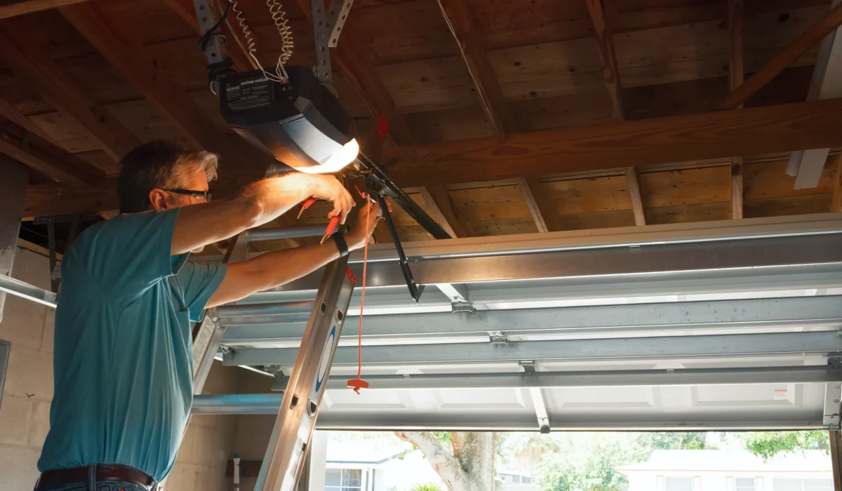 A man is repairing the garage door